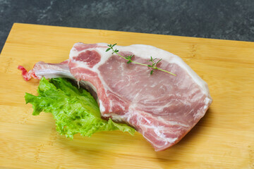 Raw pork bone steak over wooden