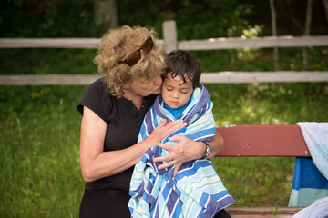 grandma cuddles her towel wrapped grandson