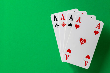 four aces on green background