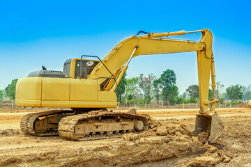 Excavator is digging the soil for clearing site construction. Excavator is heavy construction equipment consisting of a boom, dipper, bucket and cab on a rotating platform.