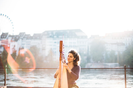 Woman playing harp on the streets of Basel