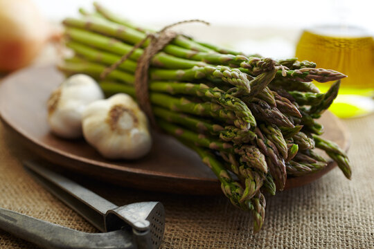 Asparagus with garlic on wood plate