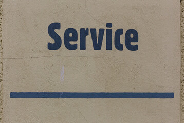 Service in blue paint on yellow wall