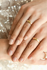Obraz na płótnie Canvas Close up of wedding rings on hands of newlyweds. Hands of the bride and groom