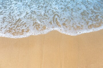 Fototapeta na wymiar White wave on fine sand beach, nature concept background, clean environment