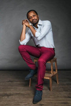Thoughtful stylish black man in causal outfit in studio