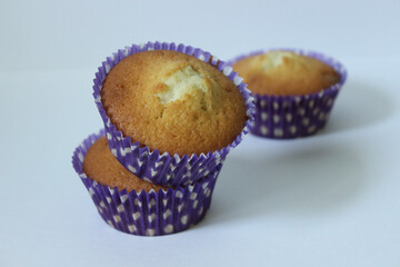 Vanilla three cupcakes in a blue wrapper .Texture or background