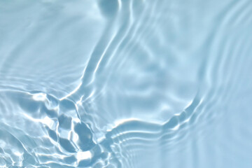 Blurred transparent blue colored clear calm water surface texture with splashes and bubbles. Trendy...