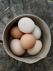 Village chicken eggs yellow and white lie in a pot .Texture or background