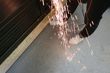 A man creating sparks from grinding.