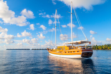 Sailing ship on the background of a tropical island in the Indian ocean