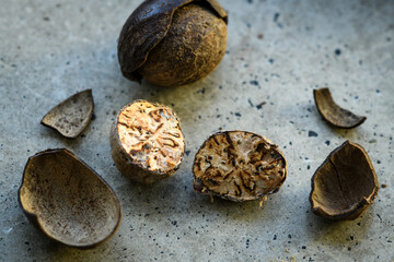 Cut nutmeg on a concrete table