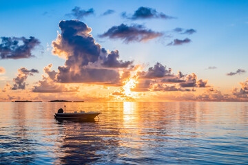 Silhouette of a motor boat at sunset in the Indian ocean