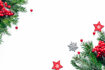 Christmas and New Year card with fir branches and decor on the white background. Copy space. Top view.