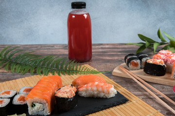 Sushi rolls and a bottle of fresh juice