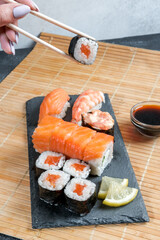 Sushi set. Japanese sushi, rolls, soy sauce, ginger, chopsticks