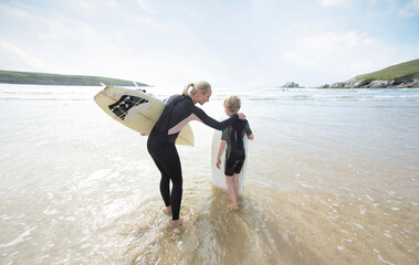 Mother and Son surfing together.