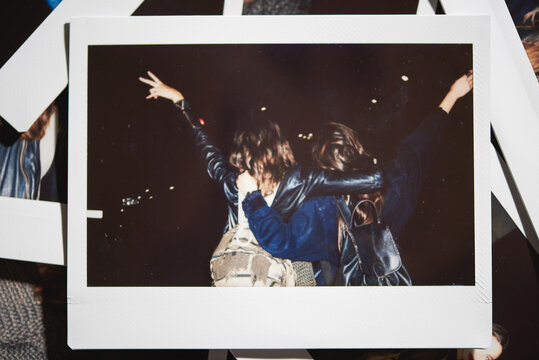 polaroid: from behind, two women