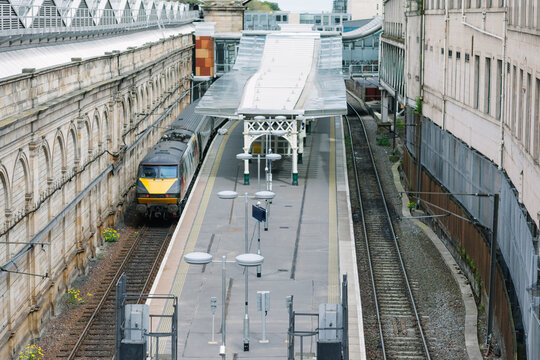 Train coming into a European station platform.