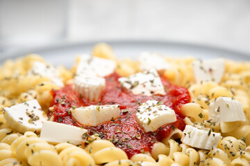 Close up of pasta with tomato sauce and cheese
