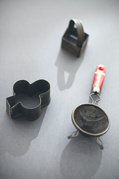 kitchen utensils on grey background backlit with shadows