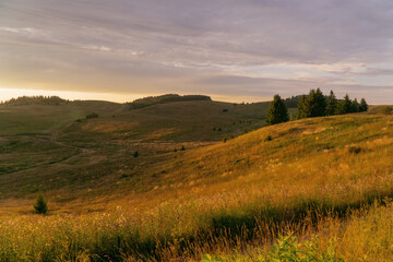 Fototapeta premium sunset over hilly fields in summer in Bashkiria
