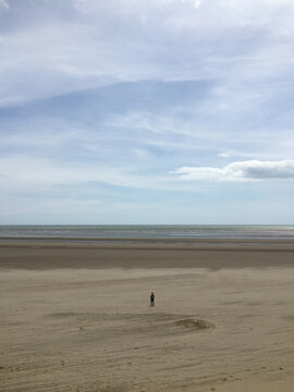 Overhead image of lone boy on beach