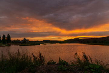 Fototapeta na wymiar sunset over a small lake in summer in Bashkiria
