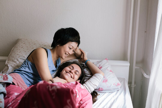 Lesbian couple lying in bed