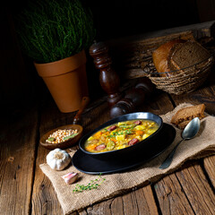 Rustic pea soup with bacon and sausages