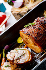 Lecere roll roast with vegetables and herbs.