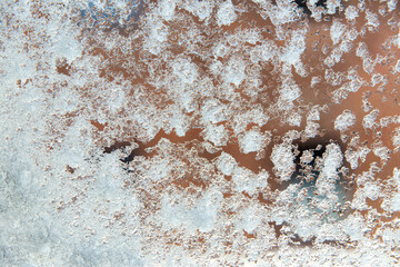winter weather concept - window glass covered with snow and ice after blizzard