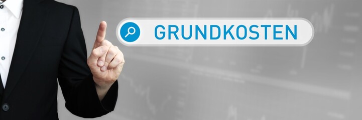 Grundkosten. Mann zeigt mit Finger auf Suchfeld im Internet-Browser. Wort/Text (blau) in der Suche.