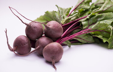 Branch of freshly picked fresh natural beet on a white background, copy space. Vegetarian concept.