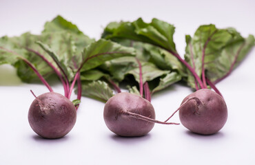 Three fresh natural organic beets on a white background with copy space. Close up.