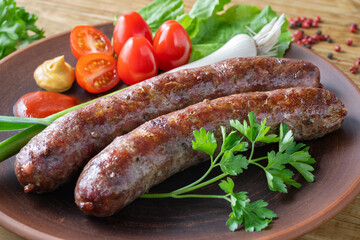 Food poster, restaurant setting - a portion of grilled sausages with tomatoes and herbs, ketchup, mustard. On a rustic table.