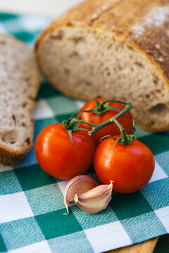 Bread and tomato on wooden table