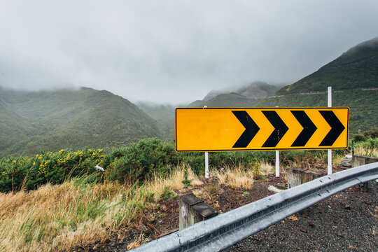 A sign on the corner of a country road