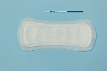 simple pregnancy test and an empty pad.the concept of no menstruation during pregnancy. the international contraception day on September 26.