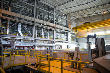 Interior of urban thermal power plant, industrial turbines, pipes