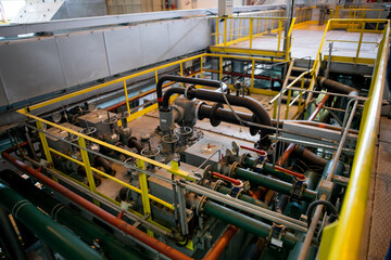 Interior of urban thermal power plant, industrial turbines, pipes