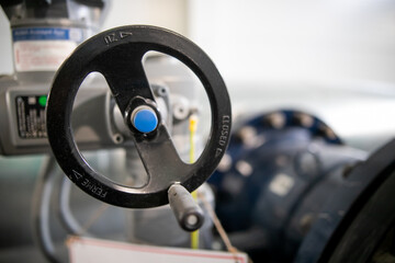 Close-up of industrial gate valve with focus on stem and nut of the hand wheel