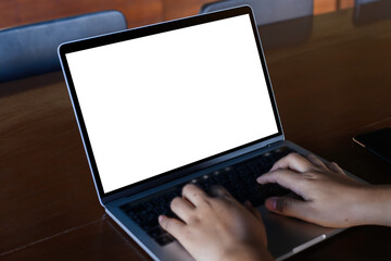 Businesswoman hand using laptop computer mockup white background on desk at coffee cafe. computer with blank screen.
