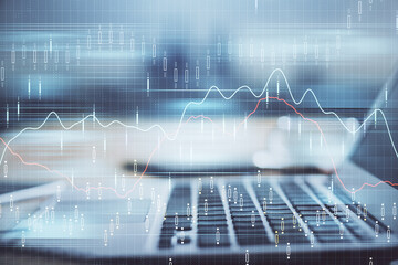 Financial graph colorful drawing and table with computer on background. Double exposure. Concept of international markets.