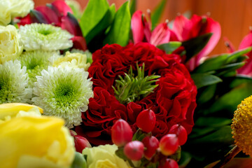 Lovely big bouquet of flowers red roses white chrysanthemums small red flowers green leaves