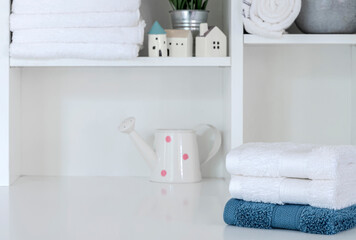 Obraz na płótnie Canvas Mockup stack of clean towels on white woode shelf, copy space.