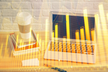 Financial chart drawing and table with computer on background. Double exposure. Concept of international markets.