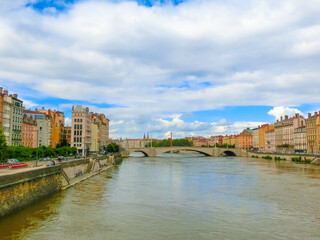Fototapeta na wymiar Lion, France - View from river Sona to the bridge and Lyon city