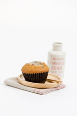 muffin, napkin and bottle on white background