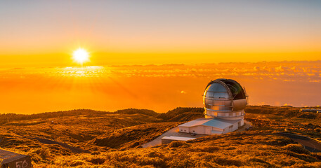 Large Canary Telescope called Grantecan optico del Roque de los Muchachos in the Caldera de Taburiente in a beautiful orange sunset, La Palma, Canary Islands. Spain © unai
